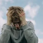 young blond guy with head in hands Why Am I Addicted to Porn