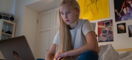 Girl on laptop in her bedroom internet safety tips